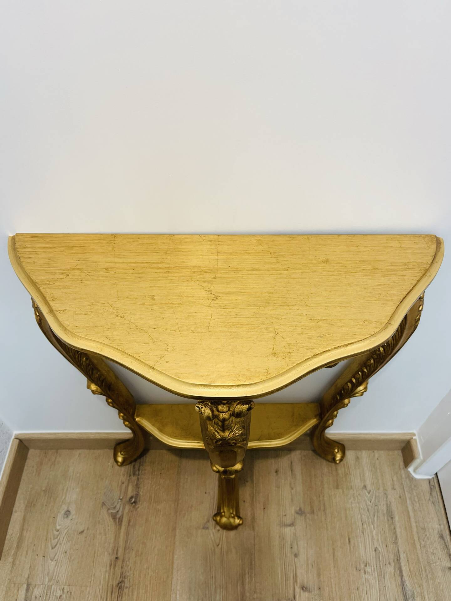 Golden console in Louis XV Rococo style made of resin.