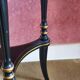 Tripod stool in blackened wood with painted floral decoration.