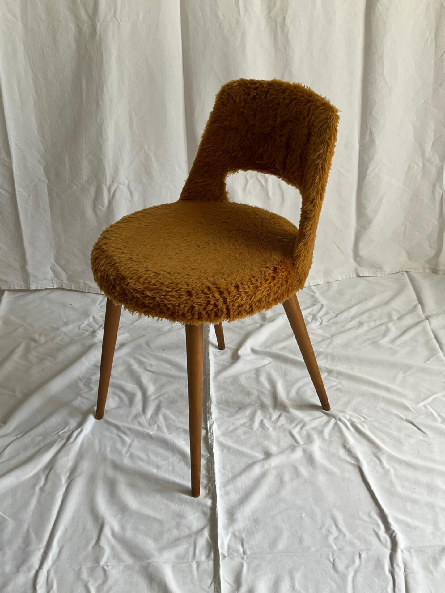 Camel barrel chair with faux fur by Baumann