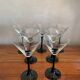 7 thin black stemmed glasses
