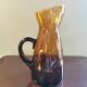 Vintage pitcher in amber glass