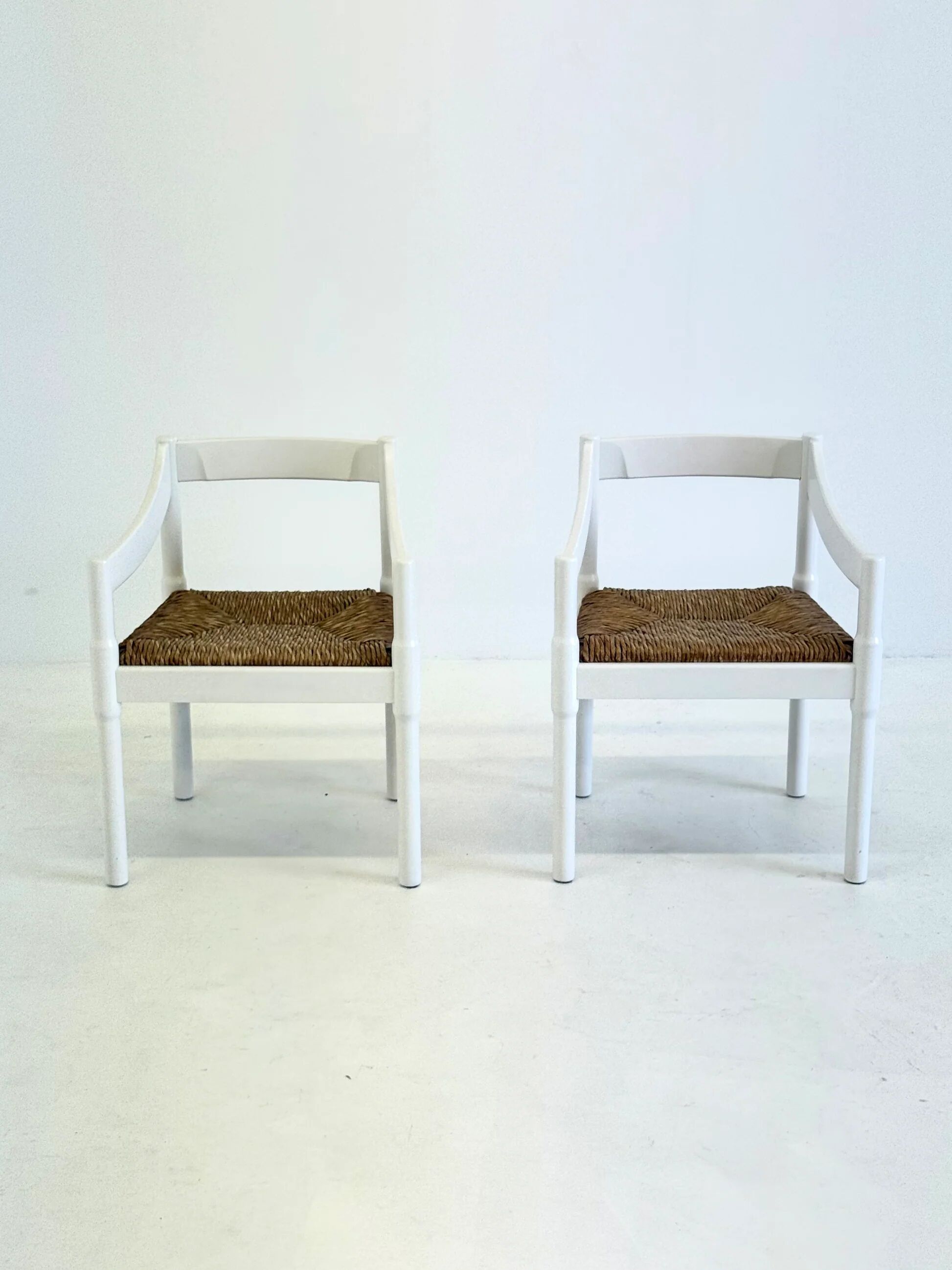 Set of two Carimate chairs by Vico Magistretti in white