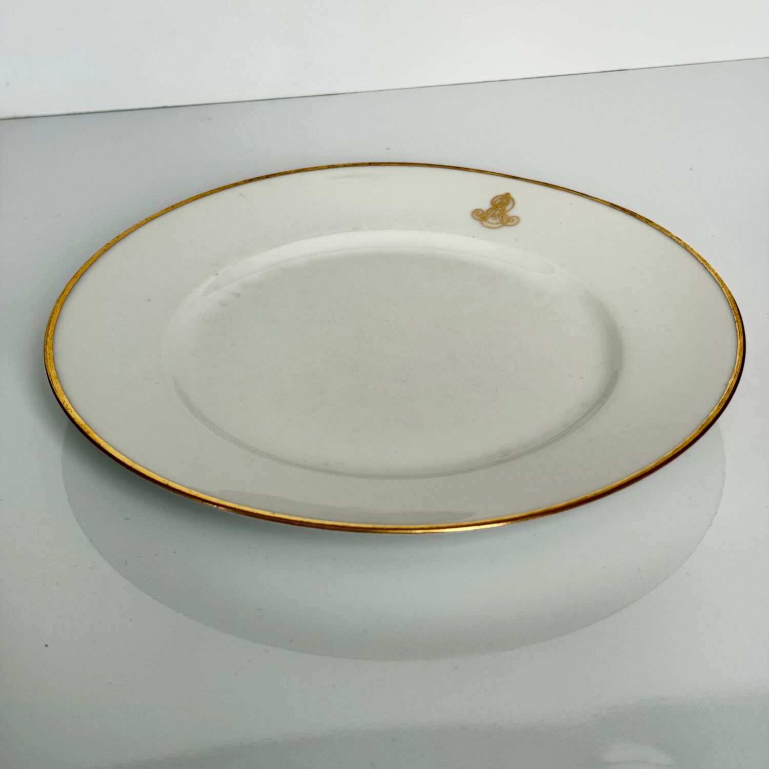 Set of monogrammed plates with gilt edges | E. Bourgeois | Late 19th century