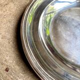 Round, hollow silver-plated metal dish
