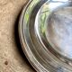 Round, hollow silver-plated metal dish