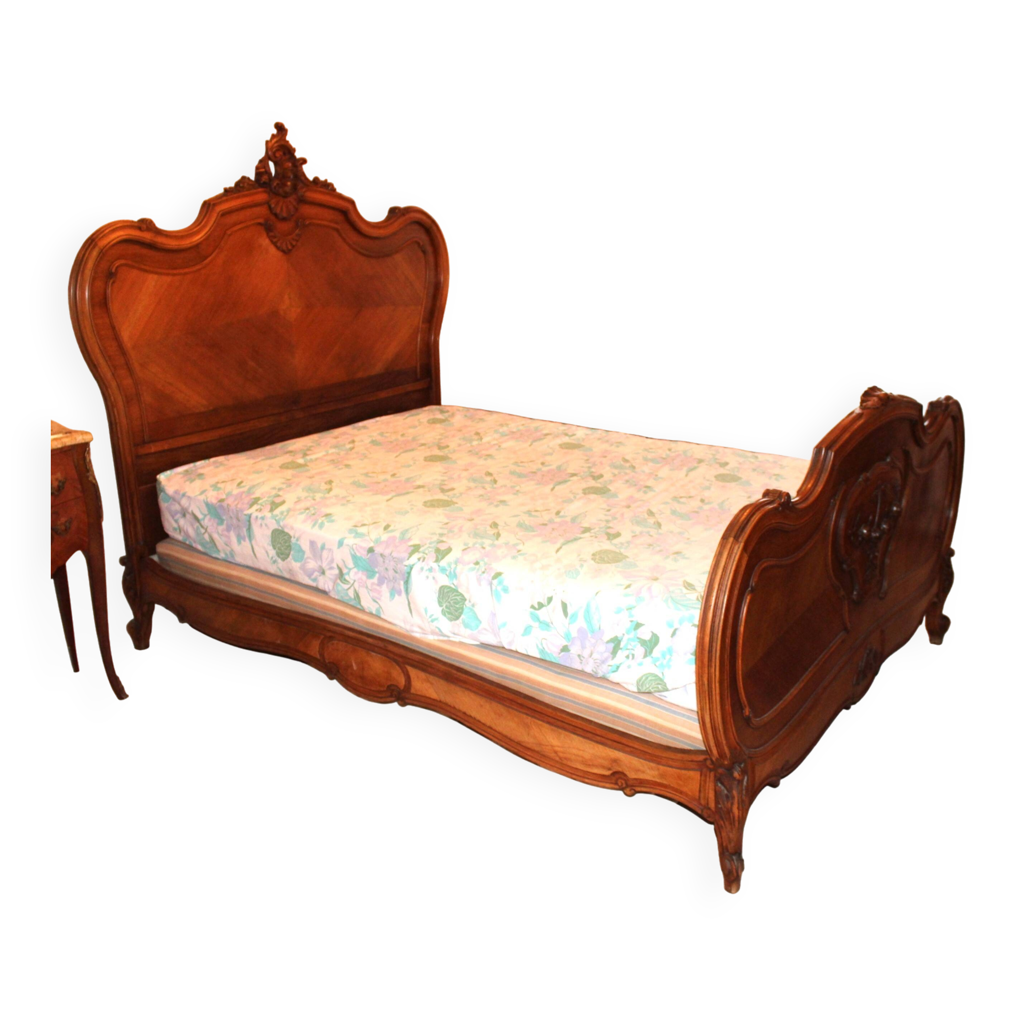 Walnut rocaille bed from the early 20th century.
