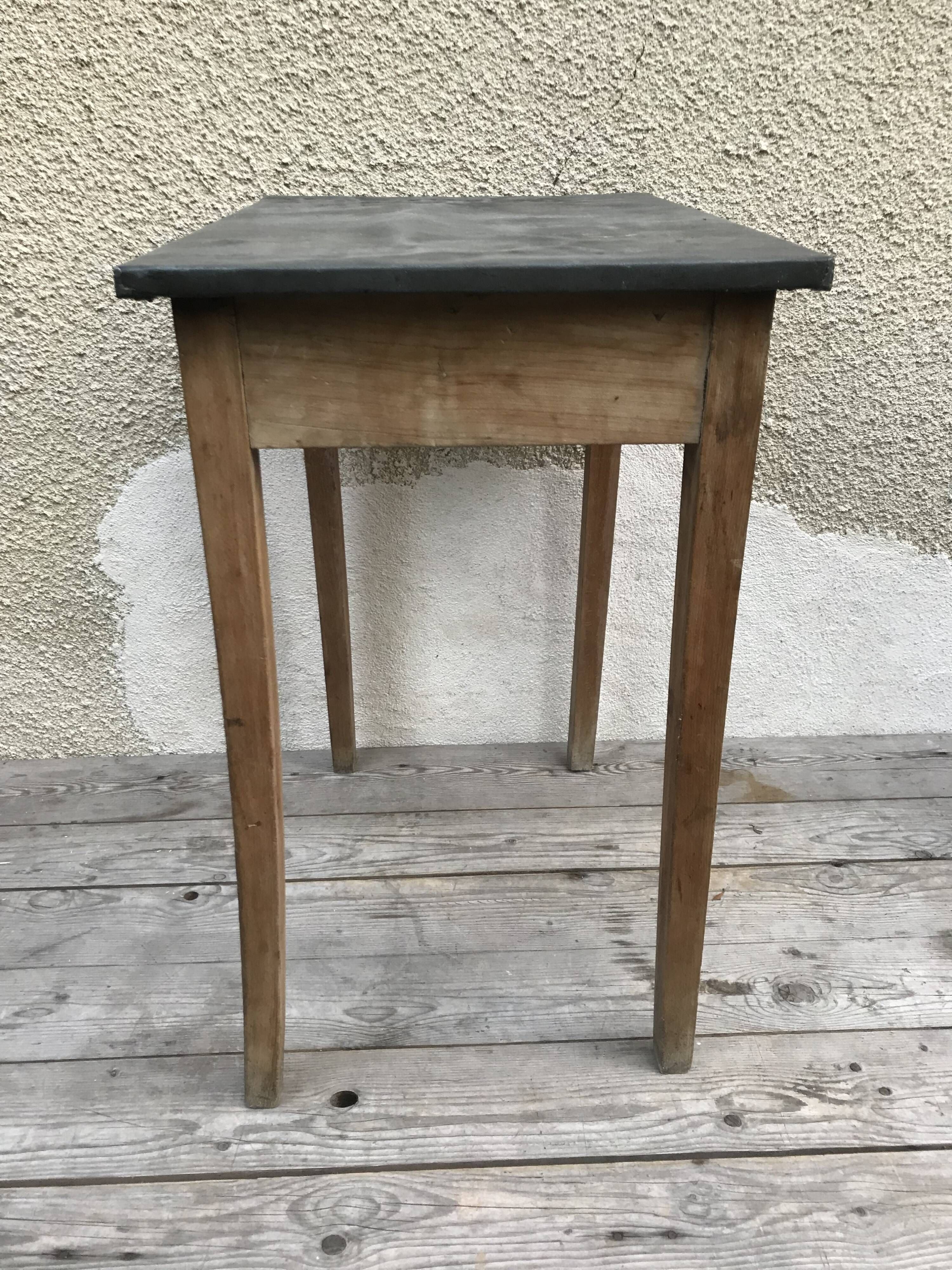 Old kitchen table in wood with compass feet