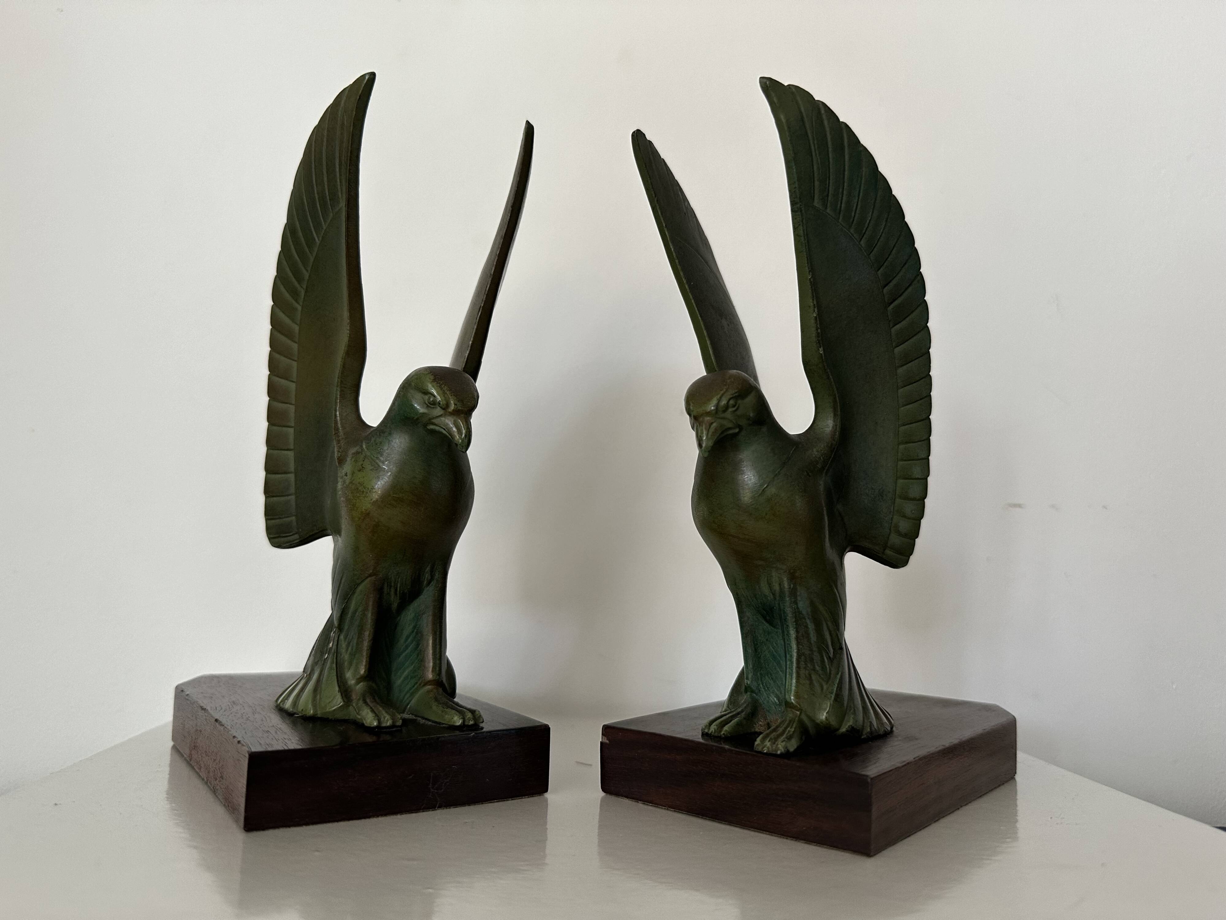 Pair of eagle bookends in green patina regula with rosewood base