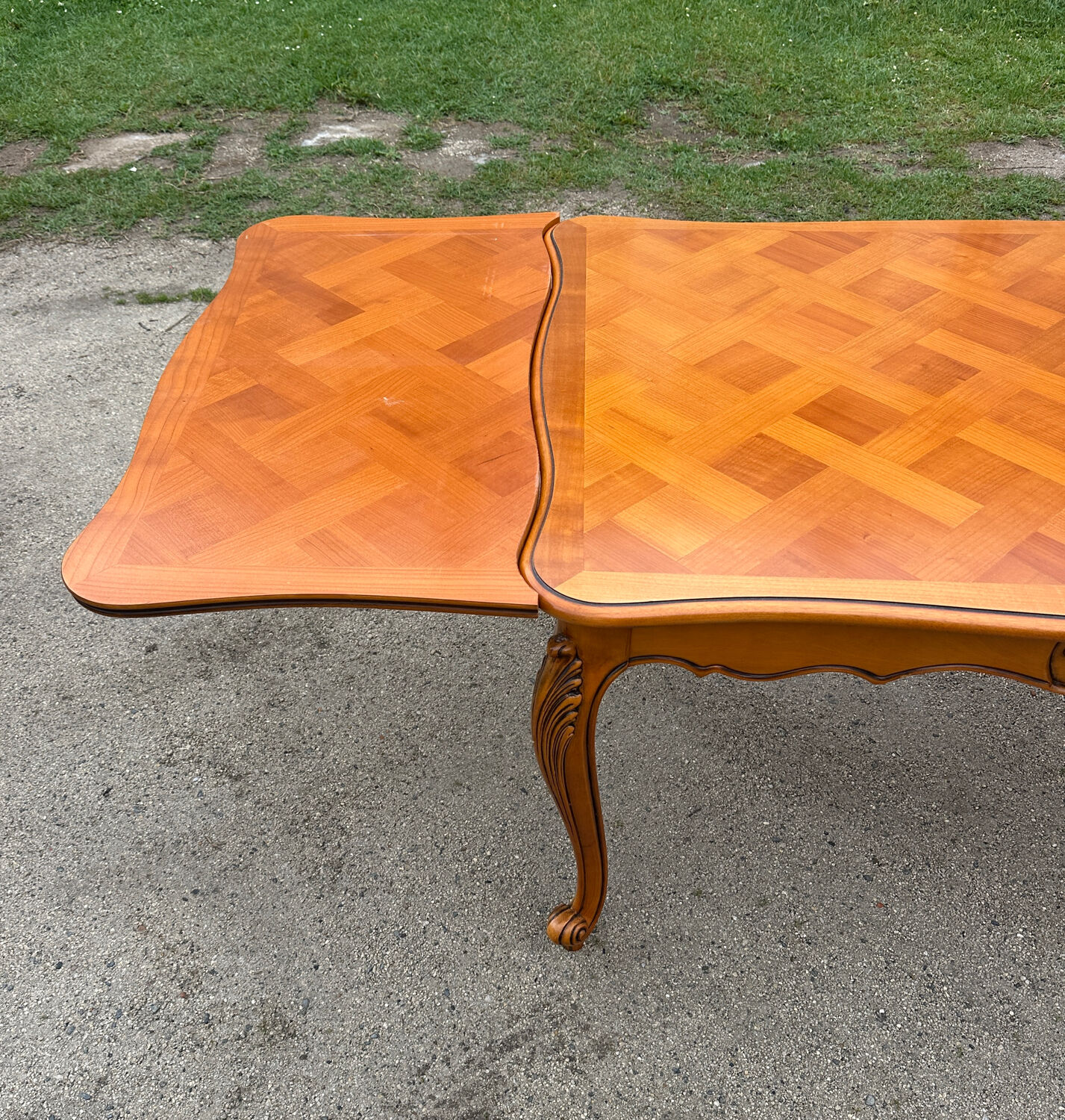 Antique extendable table in cherry wood and marquetry in the Louis XV style.