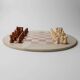 Vintage 1980s round chess set in marble, with a beige and pink marble board and wooden pieces.