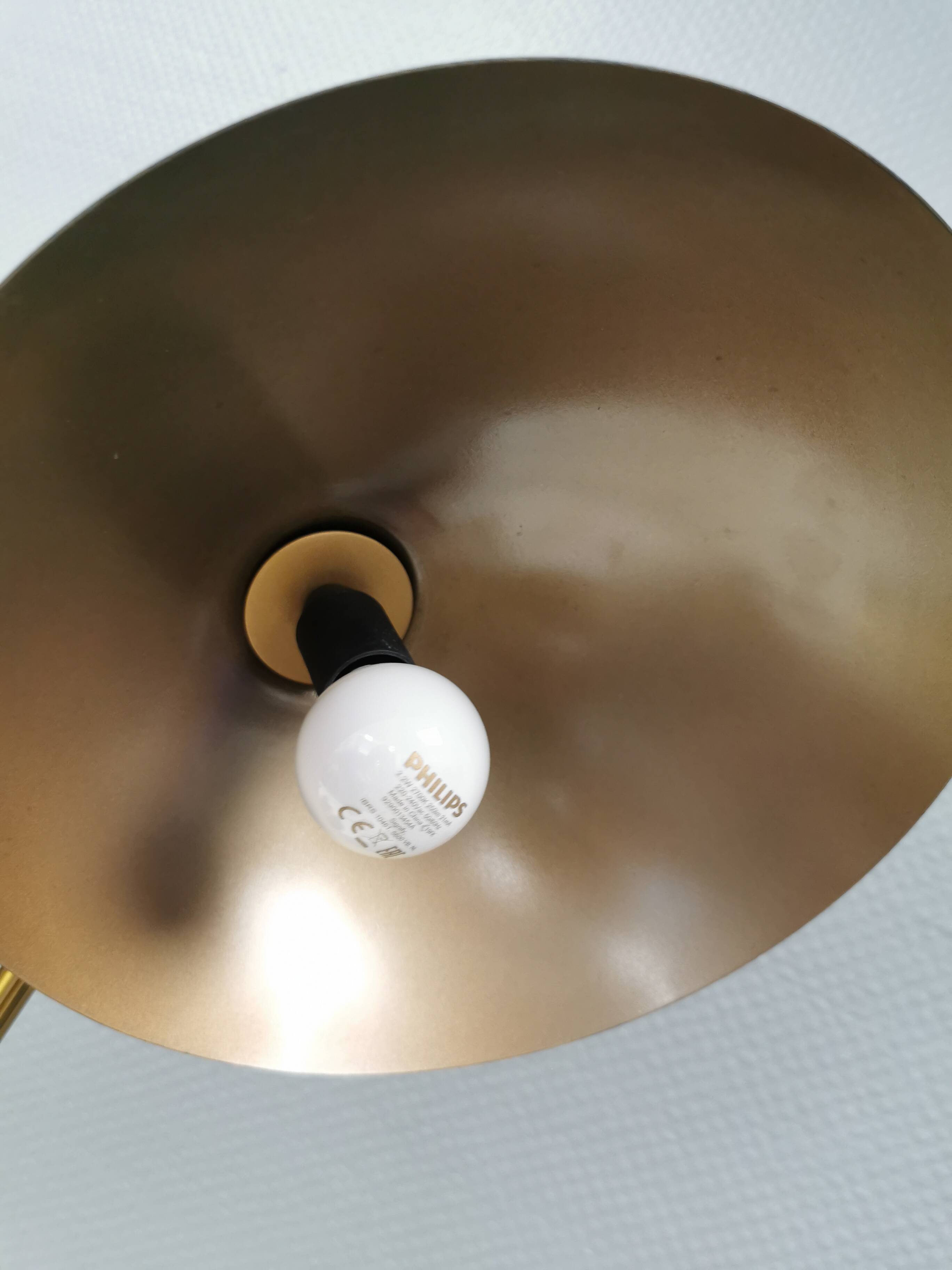 A wall lamp in black and brass-coloured finishes. Danish, early 2000s.