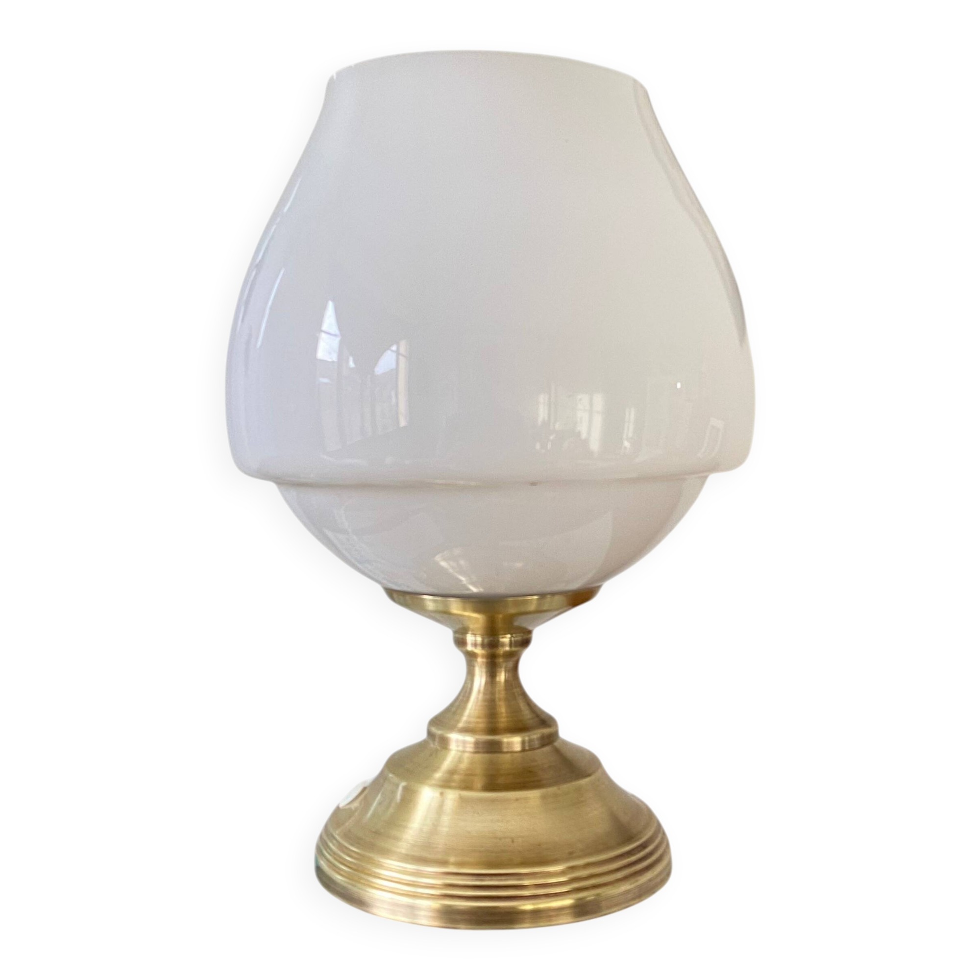 Antique white opaline glass globe table lamp with a brass base.