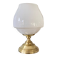 Antique white opaline glass globe table lamp with a brass base.