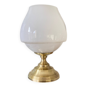 Antique white opaline glass globe table lamp with a brass base.