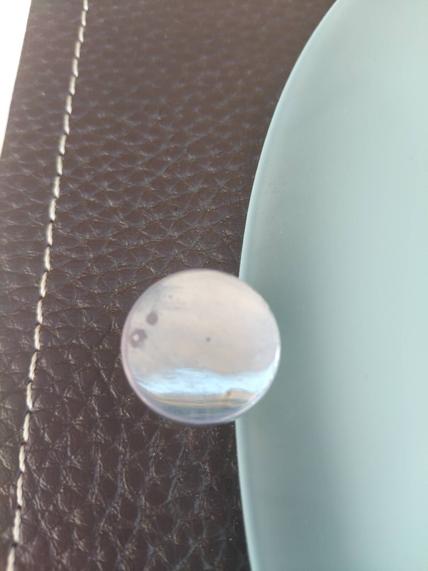 Wall light or ceiling light in frosted glass and leather-like material.