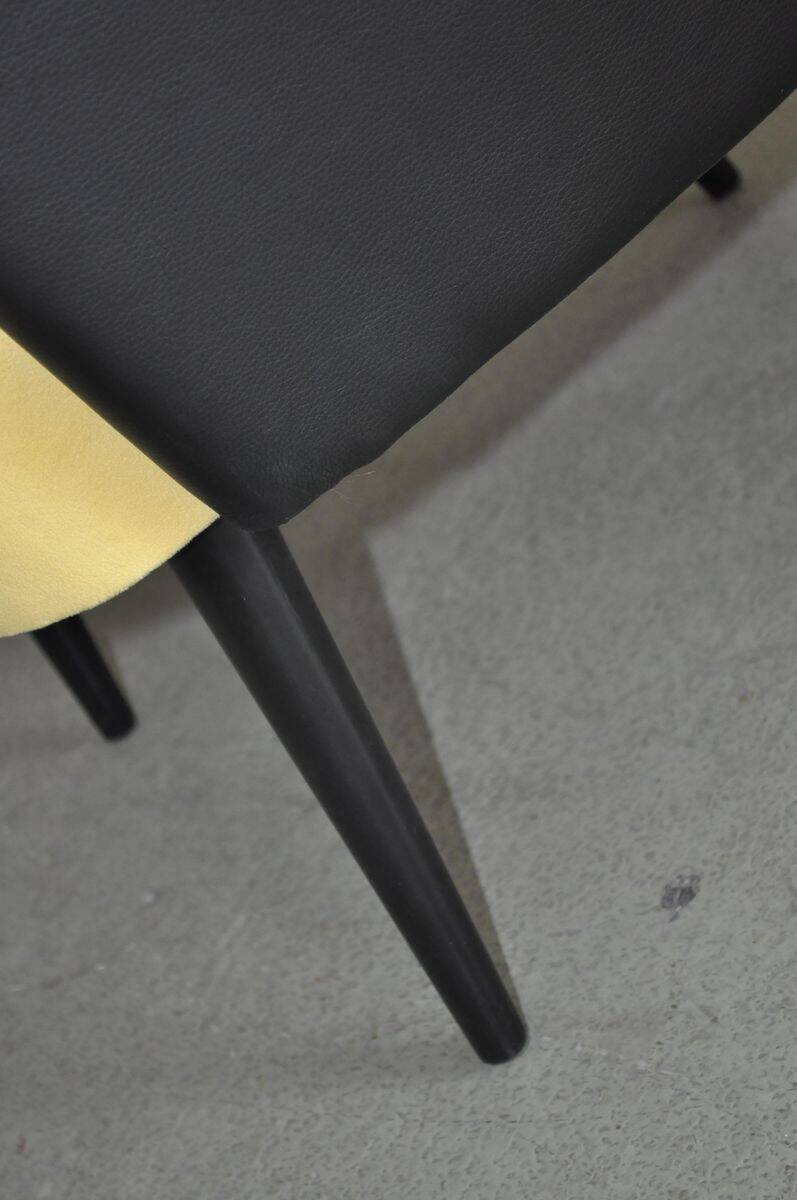 Pair of vintage 1950s cocktail chairs in yellow velvet and black faux leather, wooden frame.