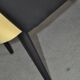Pair of vintage 1950s cocktail chairs in yellow velvet and black faux leather, wooden frame.
