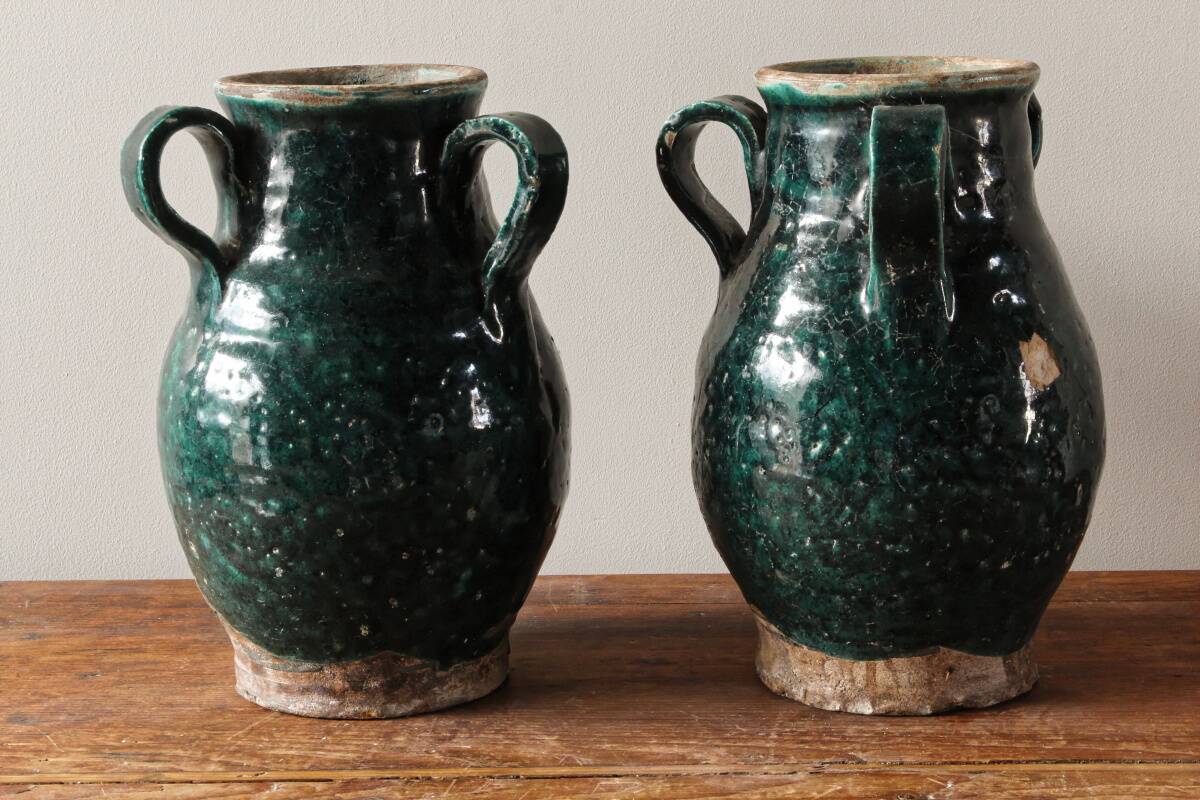 Set of two Chinese green glazed stoneware storage jars.