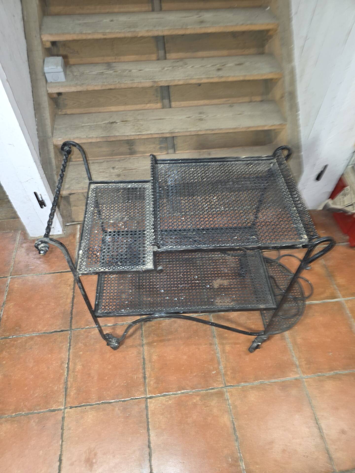 Perforated wrought iron rolling dessert trolley