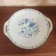 Round serving dish with handles (probably a cake dish or a plate)