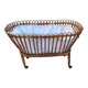 Vintage rattan bed on wheels cradle