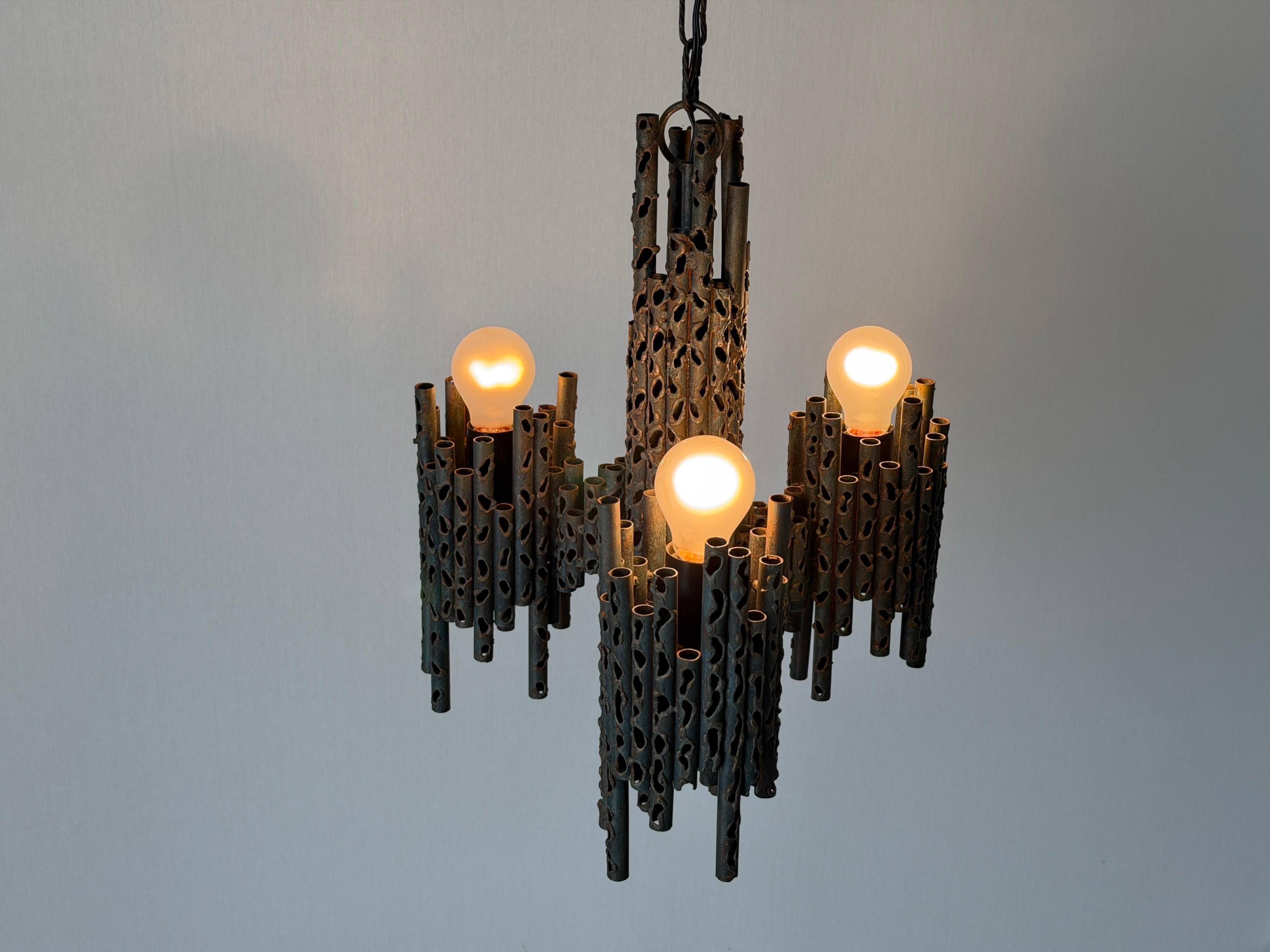 Three-armed suspended lamp in wrought iron, brutalist design, 1960s, Italy.