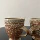 Set of 2 enamelled stoneware mugs with stylised polka dots.
