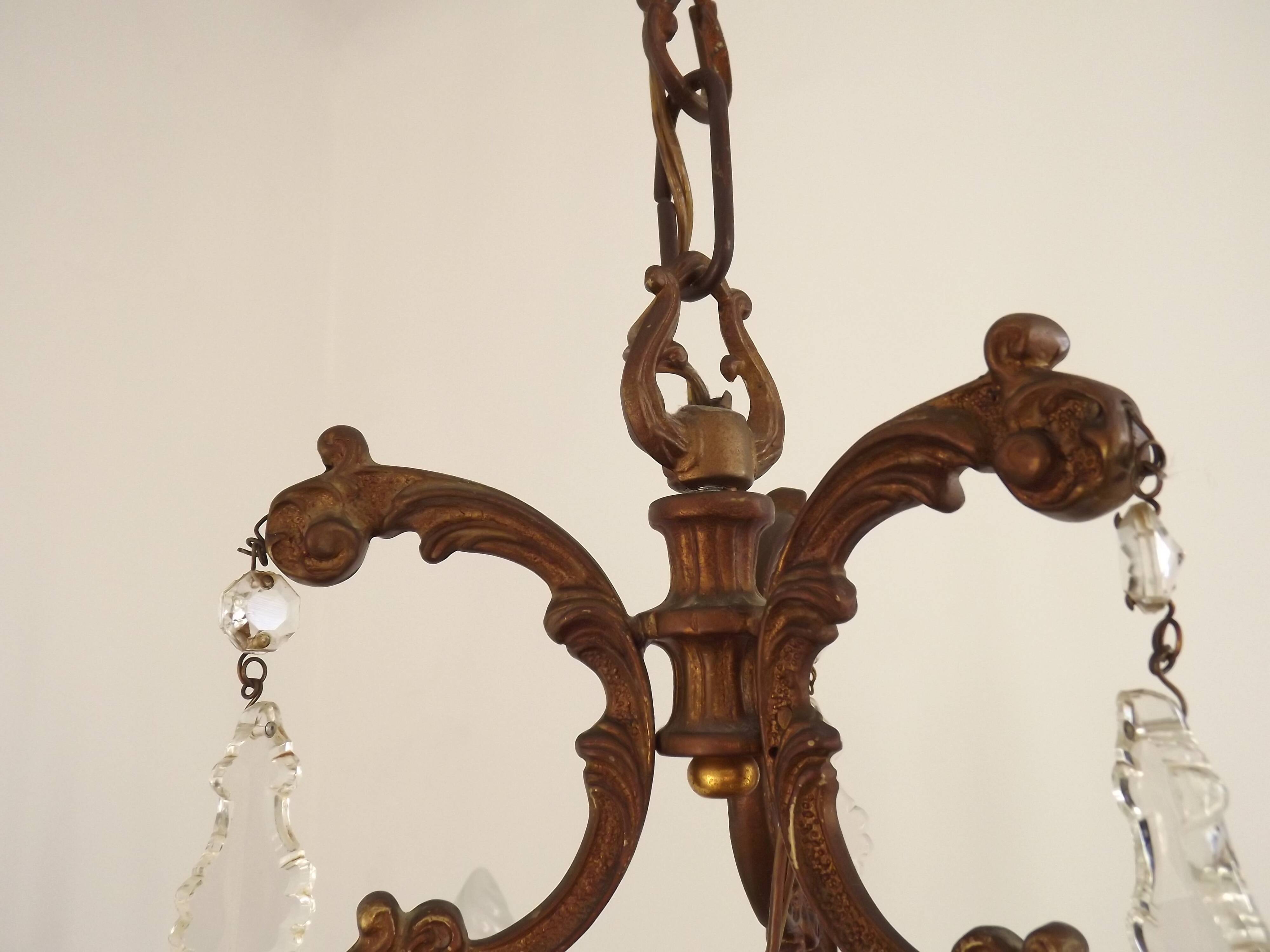 Antique French bronze chandelier with 6 lights and matching crystals.