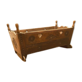 Sculpted walnut rocking cradle