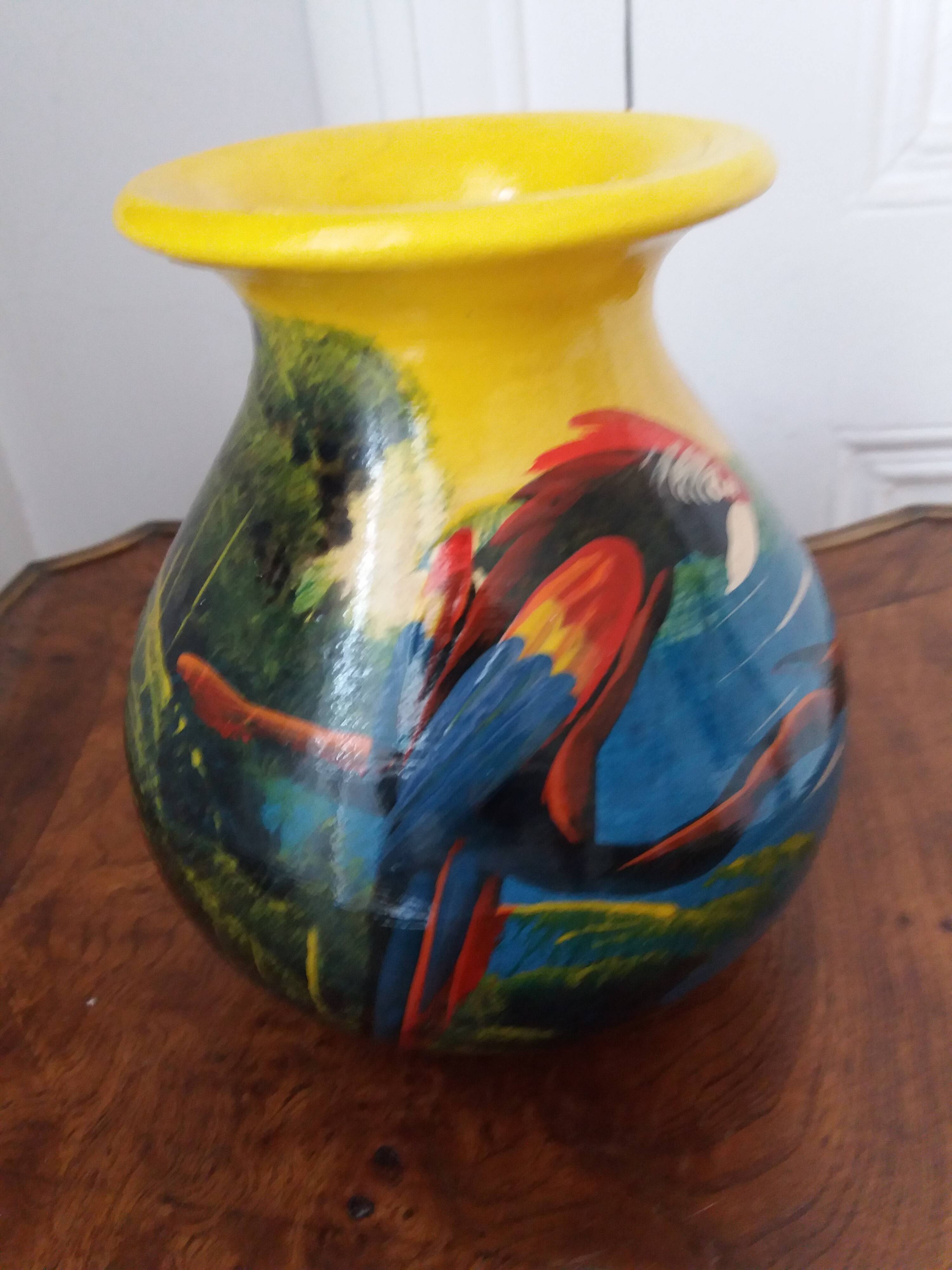 Mexican popular art vase decorated with parrots and toucans.
