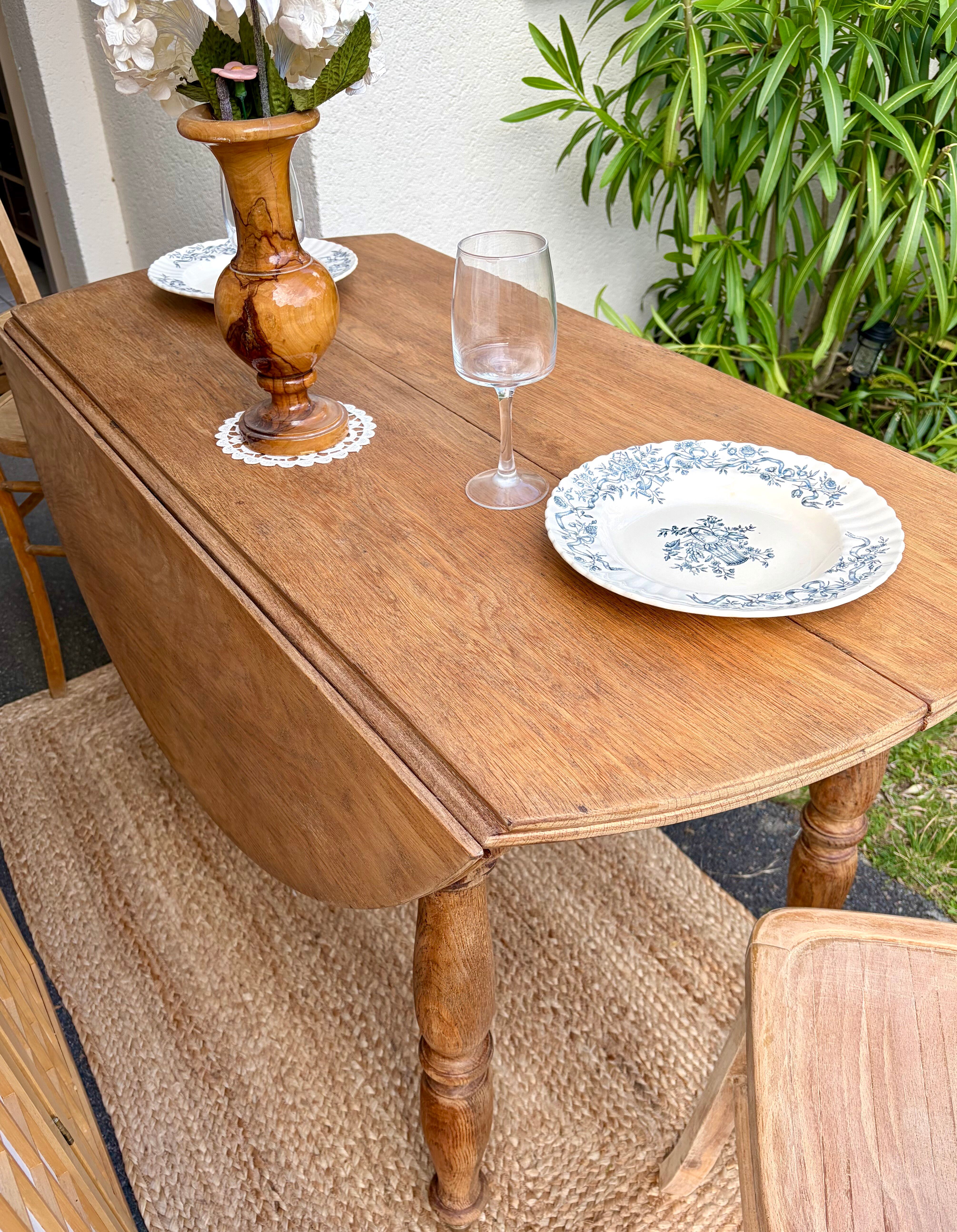 Round oak table with a drop leaf.