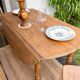 Round oak table with a drop leaf.
