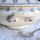Antique mismatched earthenware soup plates with a tureen