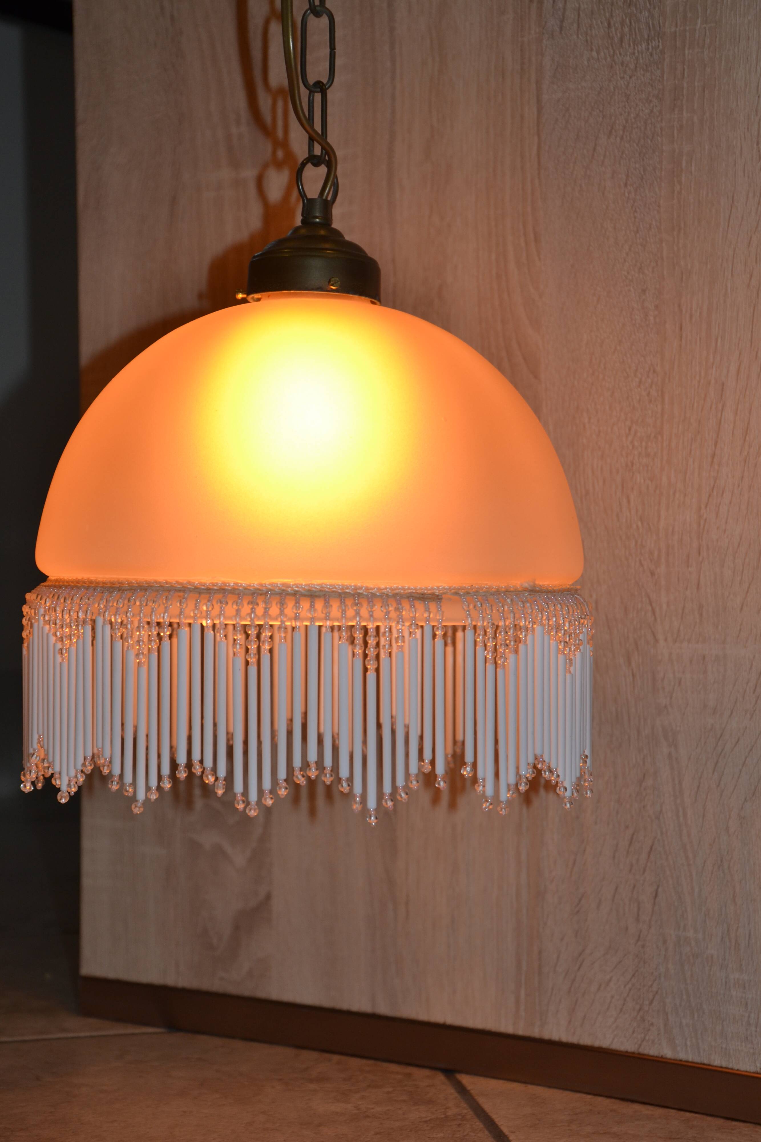 Lustrous suspension in glass paste, glass and ceramic pendants.