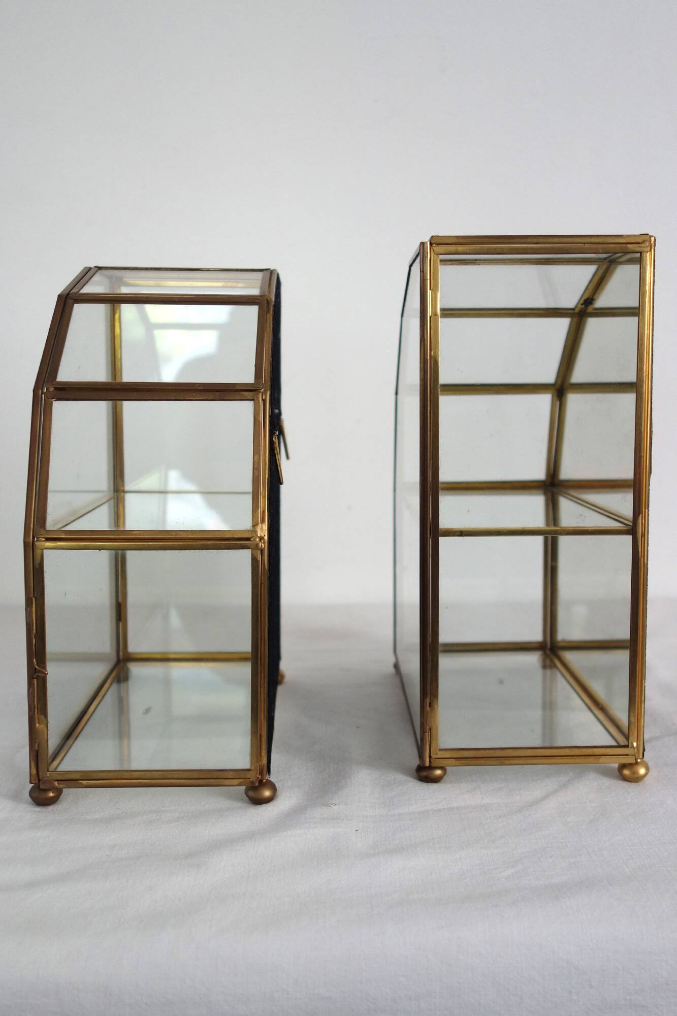 Pair of gilded brass, glass, mirror display cases from the 60s