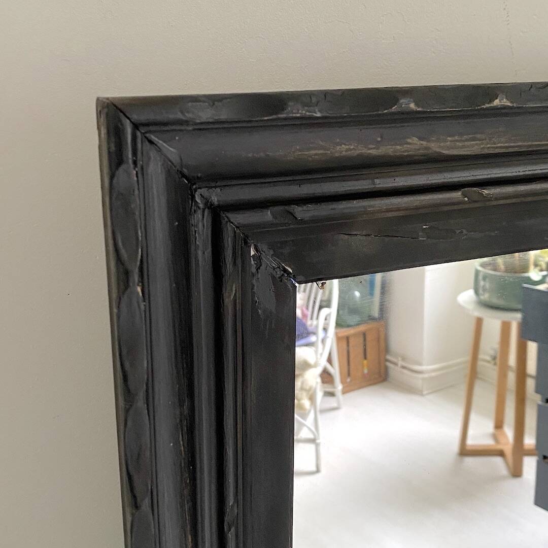 1950s mirror, matte black wood with a patina.