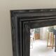 1950s mirror, matte black wood with a patina.