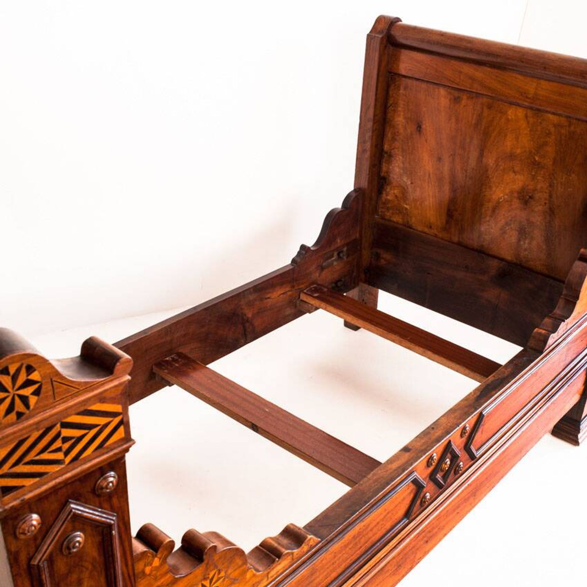 Bed made of solid walnut with marquetry details. France, 1930s.