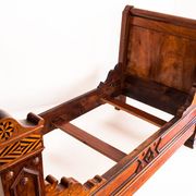 Bed made of solid walnut with marquetry details. France, 1930s.