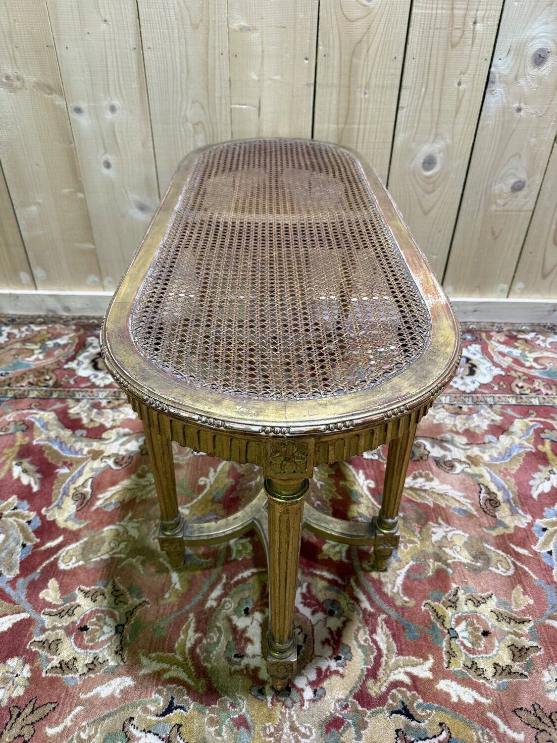 Bench - Piano bench in caning and gilded wood in the Louis XVI style.