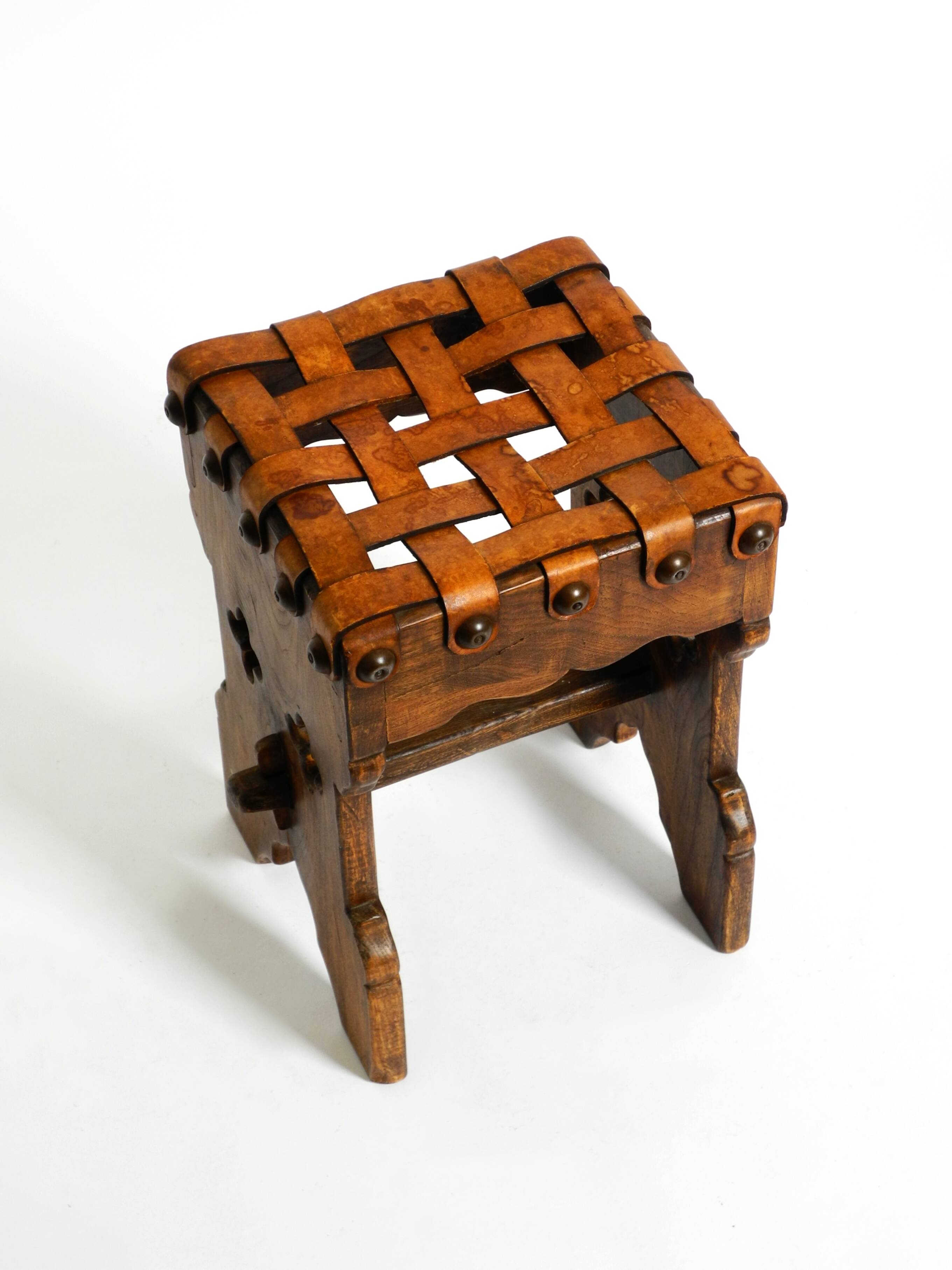 Beautiful 1940s oak stool with a seat made of leather straps