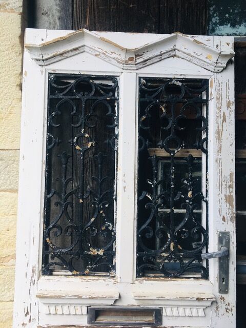 Old door with wrought iron grille