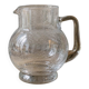 Vintage blown glass pitcher with bubbles, transparent.