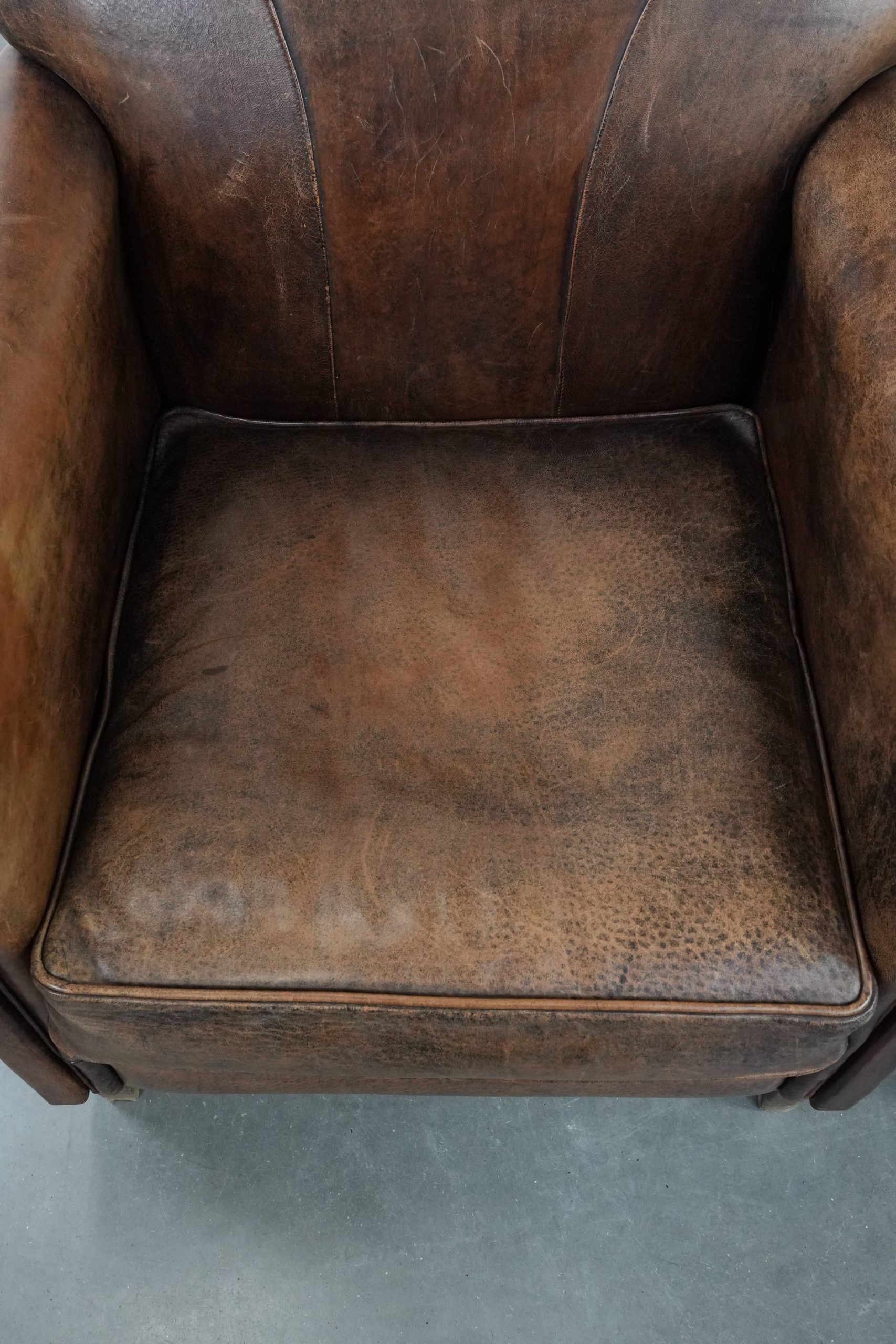 Set of 2 vintage sheepskin armchairs with a characterful appearance