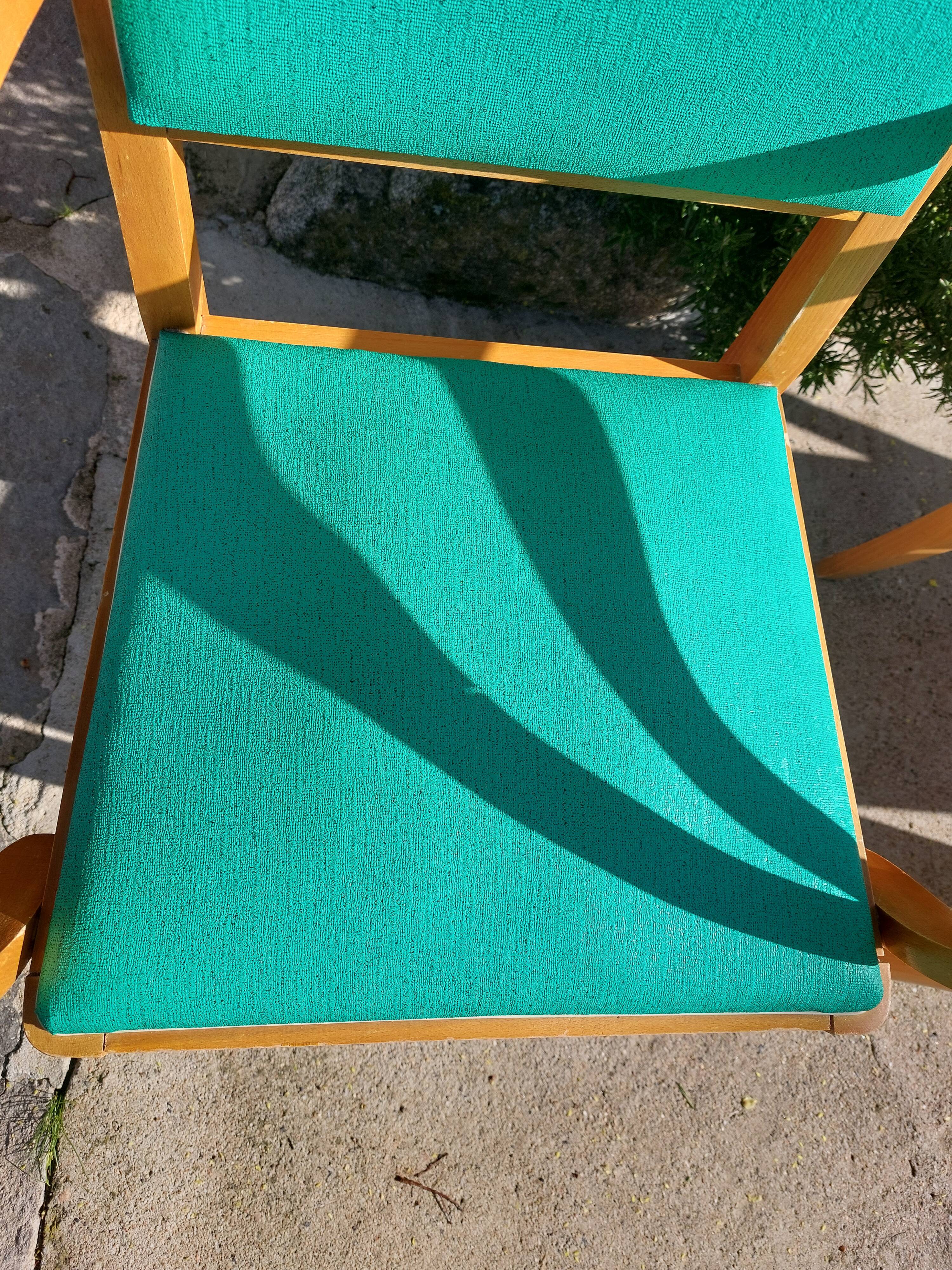 3 vintage bridge chairs with rounded armrests.