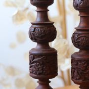 Pair of turned and carved wooden candlesticks