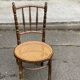 Vintage 19th-century bistro chair made of curved solid wood and caned in the Thonet style.