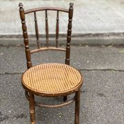 Vintage 19th-century bistro chair made of curved solid wood and caned in the Thonet style.