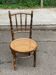 Vintage 19th-century bistro chair made of curved solid wood and caned in the Thonet style.