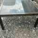 Vintage metal coffee table with glass top.